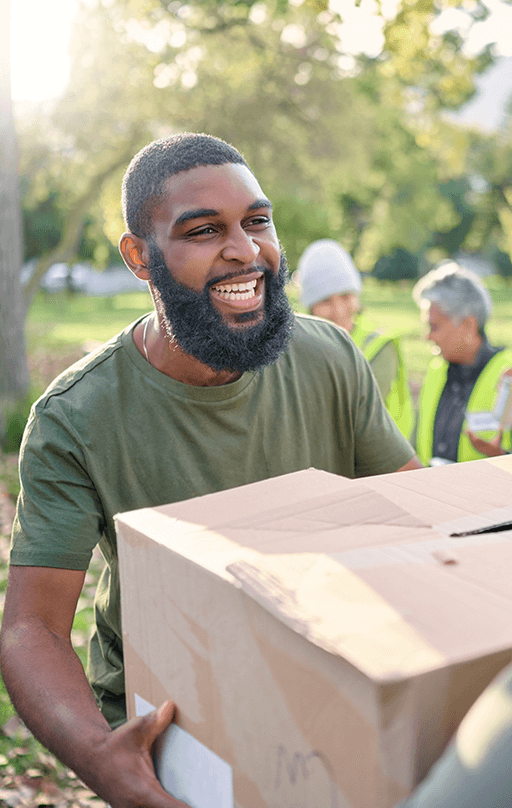 Man smiling holding box